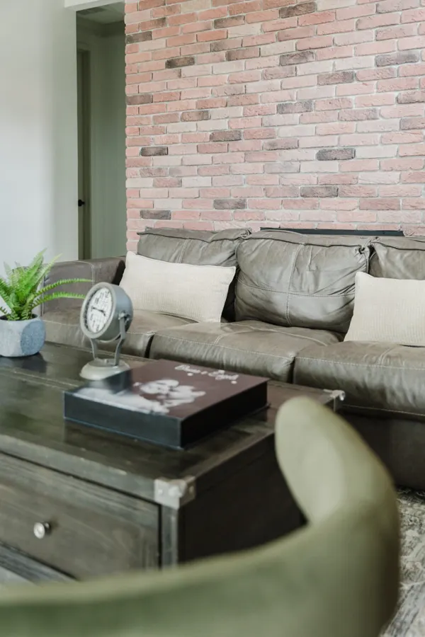 Lounge with brick accent wall