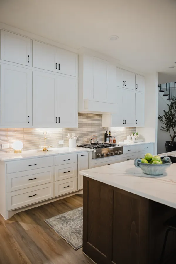 White cabinetry and wood island